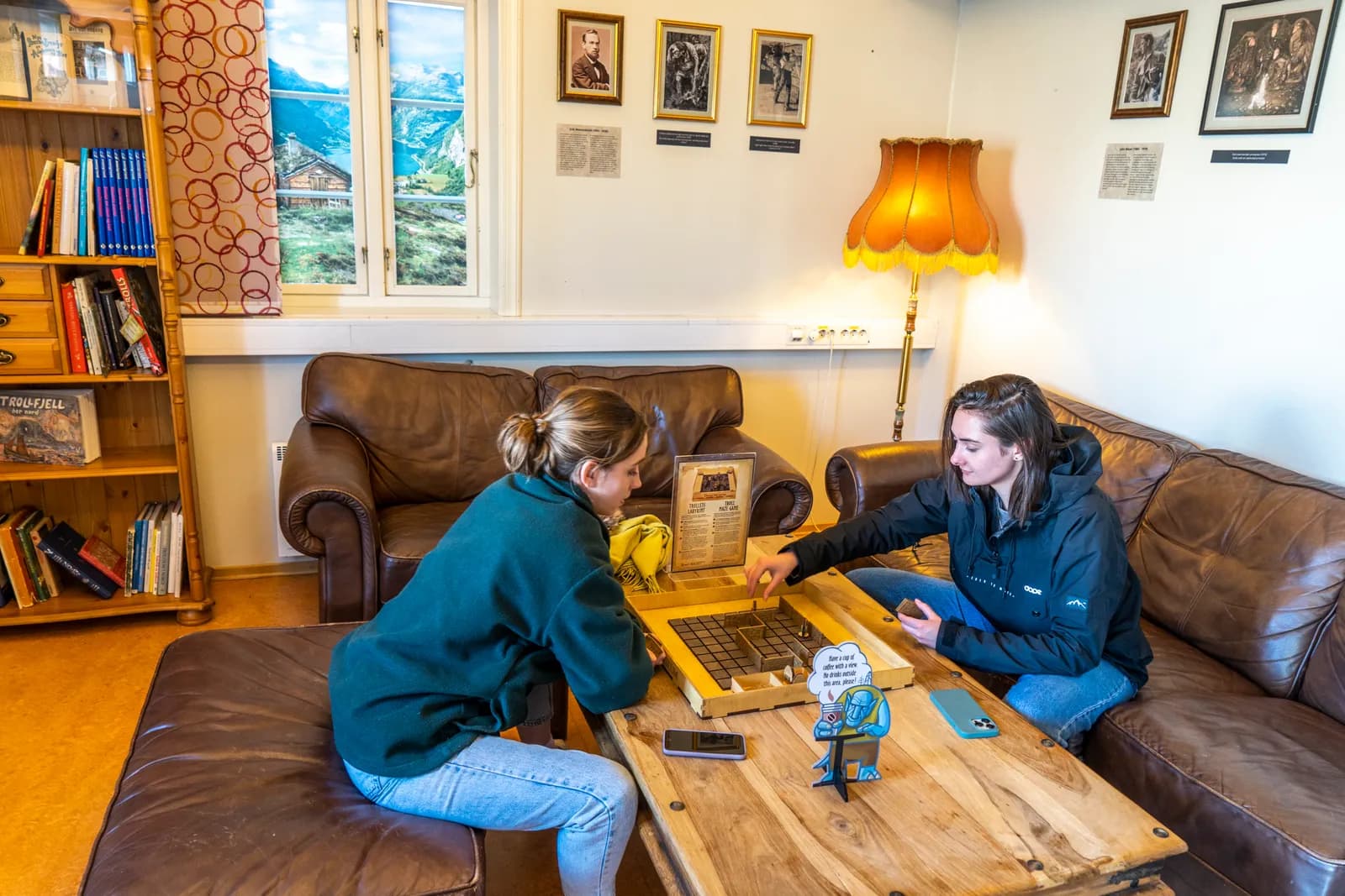 Two visitors playing the museum's troll board game in the reading room