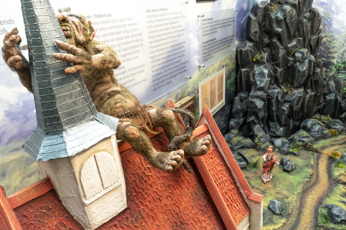 Model of folk tale about Saint Olav and the troll building a church.